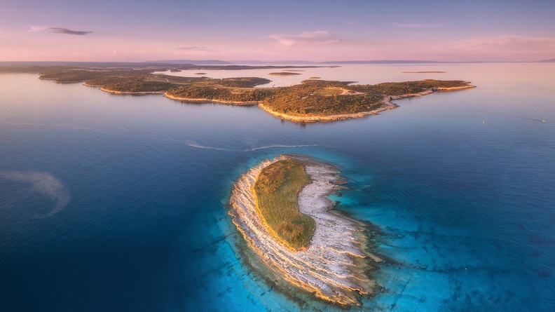 Windswepted island with light blue water, Istria, Croatia